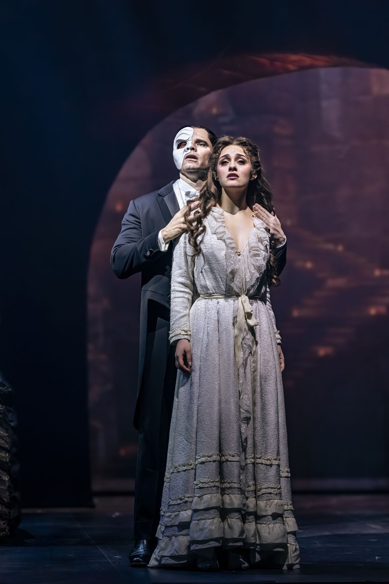 El Fantasma y Christine Daaé de cuerpo entero en el escenario a oscuras
