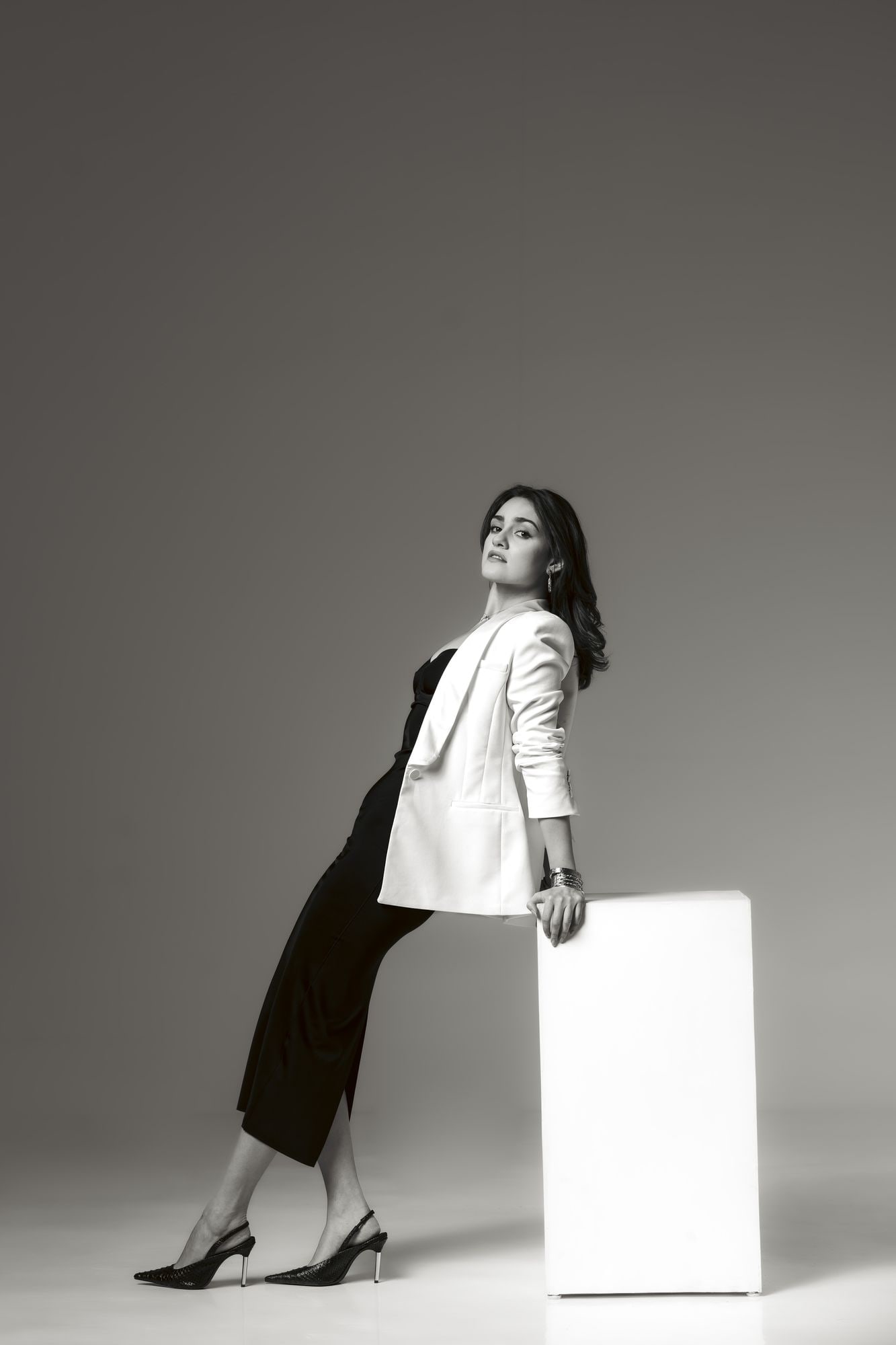 Full-length studio portrait in a white blazer