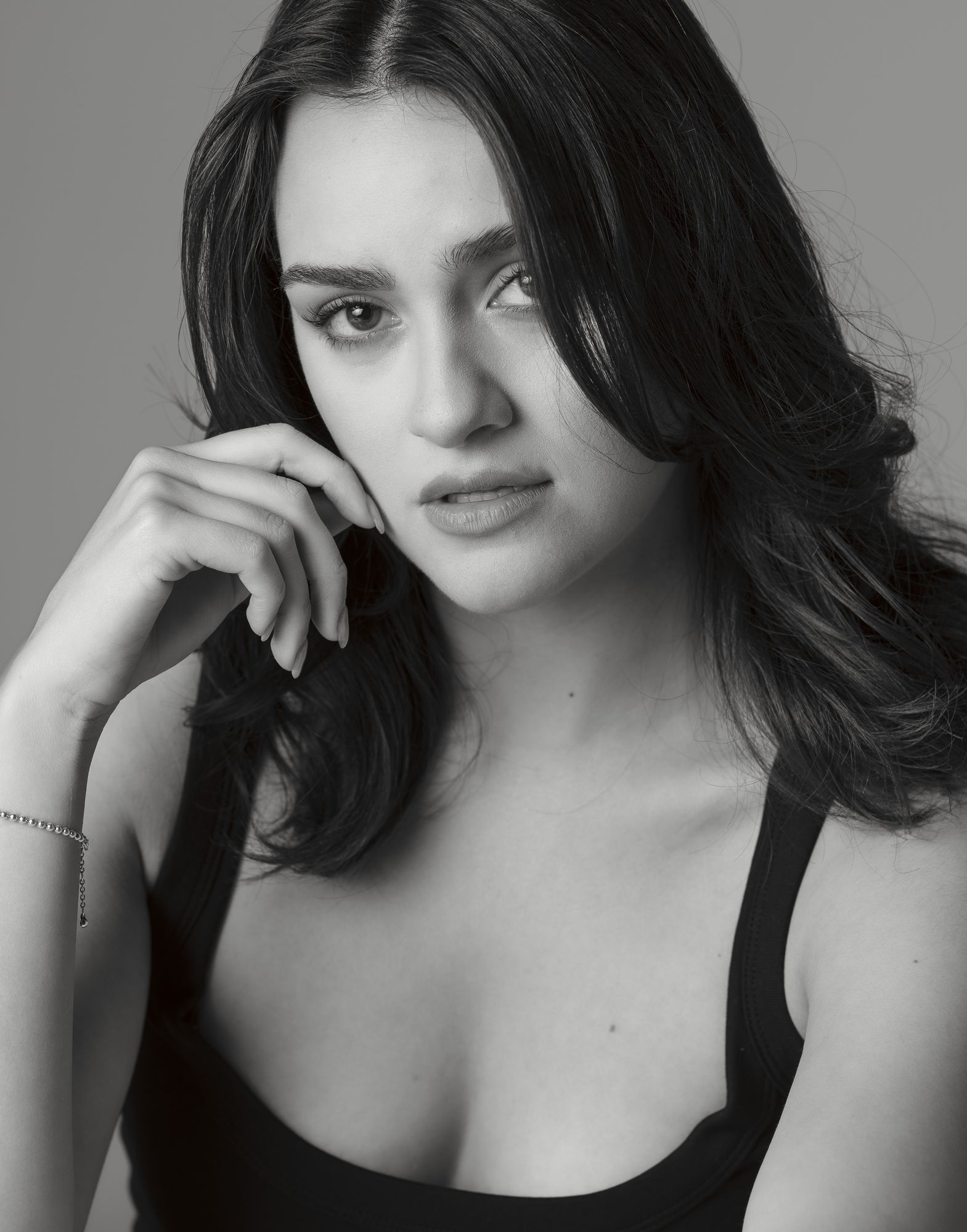 Black and white headshot, chin resting on one hand