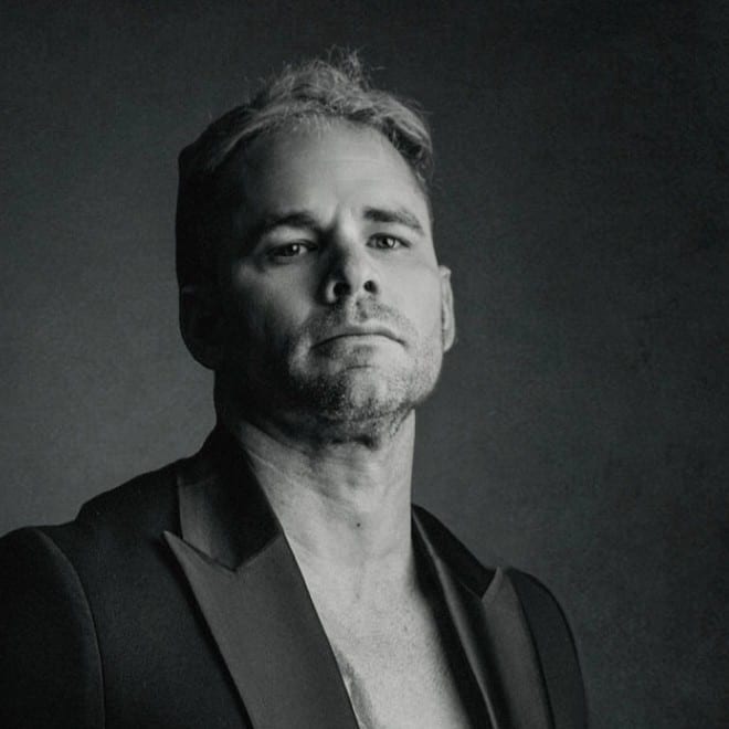 Edward Salles in a black tuxedo jacket, black-and-white studio portrait
